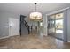 Open-concept living area with tile floors, staircase, and access to outdoor patio at 6611 S San Jacinto St, Gilbert, AZ 85298