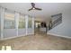Open concept living area with travertine floors, ceiling fan, and staircase with iron railing at 6611 S San Jacinto St, Gilbert, AZ 85298