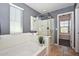 Bathroom with a glass enclosed shower, a soaking tub, and tile flooring. Natural light from the window at 6611 S San Jacinto St, Gilbert, AZ 85298