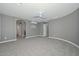 Expansive main bedroom with carpet, ceiling fan, and multiple doorways to en suite bathroom and closet at 6611 S San Jacinto St, Gilbert, AZ 85298