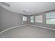 Bright main bedroom with neutral walls, plush carpet, ceiling fan, and natural light from multiple windows at 6611 S San Jacinto St, Gilbert, AZ 85298