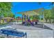Community playground featuring climbing structures, slides, and shaded seating areas at 6611 S San Jacinto St, Gilbert, AZ 85298