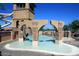 The community pool features a splash pad, rock features, and waterfall at 6611 S San Jacinto St, Gilbert, AZ 85298