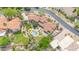 Drone shot of a house with a pool, fountain, patio, tile roof, mature trees, and lush landscaping at 700 N Dobson Rd # 34, Chandler, AZ 85224
