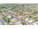 An aerial view showcases a neighborhood featuring homes with red tile roofs and swimming pools at 700 N Dobson Rd # 34, Chandler, AZ 85224