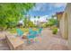 Relaxing backyard with fire pit, seating area, lush lawn, mature trees, and blue skies at 700 N Dobson Rd # 34, Chandler, AZ 85224