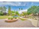 Resort-style backyard featuring a pool, fountain, outdoor bar, and lush green landscaping at 700 N Dobson Rd # 34, Chandler, AZ 85224