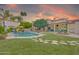 Expansive backyard featuring a sparkling pool, manicured lawn, lush landscaping, and an outdoor seating area at 700 N Dobson Rd # 34, Chandler, AZ 85224