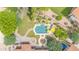 A stunning aerial view of a backyard featuring a pool, lush landscaping, a fountain, and outdoor seating areas at 700 N Dobson Rd # 34, Chandler, AZ 85224