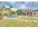 Beautiful backyard showcasing a sparkling pool, lush green lawn, fountain, and lounge areas at 700 N Dobson Rd # 34, Chandler, AZ 85224