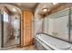 This bathroom includes a spa bath and large shower, along with elegant tiled surfaces and wooden trim at 700 N Dobson Rd # 34, Chandler, AZ 85224