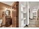 Elegant powder room features a carved wood vanity, round mirror, and unique wall sconces at 700 N Dobson Rd # 34, Chandler, AZ 85224