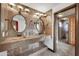 This bathroom features an open and luxurious design with tiled walls, double sinks, and a glass-enclosed shower at 700 N Dobson Rd # 34, Chandler, AZ 85224