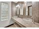 Bathroom with double sinks, tile backsplash, and decorative glass block window at 700 N Dobson Rd # 34, Chandler, AZ 85224