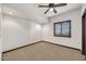 Bright bedroom with neutral carpet, ceiling fan, and a window with wooden blinds for ample natural light at 700 N Dobson Rd # 34, Chandler, AZ 85224