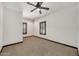 Bright bedroom with ceiling fan, neutral carpet, and shuttered windows at 700 N Dobson Rd # 34, Chandler, AZ 85224