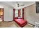 Bedroom with a comfortable chaise lounge, ceiling fan, and backyard views at 700 N Dobson Rd # 34, Chandler, AZ 85224