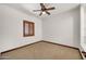 Bright bedroom with a ceiling fan, carpet, and a window with wooden blinds for ample natural light at 700 N Dobson Rd # 34, Chandler, AZ 85224