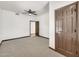 Spacious bedroom with neutral carpet, ceiling fan, and an adjacent doorway leading to another room at 700 N Dobson Rd # 34, Chandler, AZ 85224