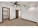 Neutral bedroom featuring carpeted floors, a ceiling fan, and a walk-in closet with organizers at 700 N Dobson Rd # 34, Chandler, AZ 85224