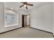 Bedroom with a seating nook, ceiling fan, and a doorway leading to another room, featuring neutral carpet at 700 N Dobson Rd # 34, Chandler, AZ 85224