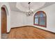 Formal dining room featuring hardwood floors, elegant chandelier, and a large window providing ample natural light at 700 N Dobson Rd # 34, Chandler, AZ 85224