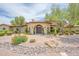Landscaped front yard with a circular driveway and a home featuring a double door entrance at 700 N Dobson Rd # 34, Chandler, AZ 85224