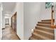 Stairway with carpet runner leading to the upper level, adjacent to a hallway with tiled flooring at 700 N Dobson Rd # 34, Chandler, AZ 85224