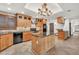 Well-equipped kitchen with wooden cabinets, black appliances, granite countertops, and center island at 700 N Dobson Rd # 34, Chandler, AZ 85224