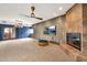 Spacious living room featuring a fireplace, TV, ceiling fan, and access to an outdoor area at 700 N Dobson Rd # 34, Chandler, AZ 85224