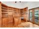Home office boasts built-in shelving, a spacious desk, and natural light, perfect for working from home at 700 N Dobson Rd # 34, Chandler, AZ 85224