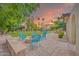 Charming patio area with comfortable seating surrounding a fire pit, perfect for outdoor entertaining at 700 N Dobson Rd # 34, Chandler, AZ 85224