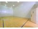 Well-lit racquetball court, ready for a competitive match, features hardwood floors and paneled door at 700 N Dobson Rd # 34, Chandler, AZ 85224