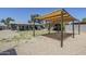 Backyard featuring a gravel area with covered patio, a storage shed, and desert landscaping at 7135 W Flower St, Phoenix, AZ 85033