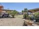 Expansive backyard with covered patio, storage shed and vehicle, desert landscaping at 7135 W Flower St, Phoenix, AZ 85033