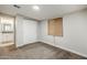 Bedroom featuring neutral carpet, blinds, and a double closet with an attached bathroom at 7135 W Flower St, Phoenix, AZ 85033