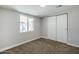 Neutral bedroom featuring a window for natural light and a built-in closet for ample storage at 7135 W Flower St, Phoenix, AZ 85033