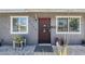 Charming home entrance featuring a decorative security door, stylish address numbers, and welcoming plants at 7135 W Flower St, Phoenix, AZ 85033