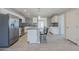 Stylish kitchen featuring white cabinets, gray countertops, a mosaic backsplash, and a center island with bar seating at 7135 W Flower St, Phoenix, AZ 85033