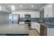 Bright kitchen boasts stainless steel appliances, a breakfast bar, and stylish mosaic backsplash at 7135 W Flower St, Phoenix, AZ 85033