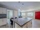 The kitchen boasts an island, stainless steel appliances, mosaic backsplash, and a breakfast bar at 7135 W Flower St, Phoenix, AZ 85033