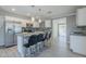 Bright kitchen boasts stainless steel appliances, a breakfast bar, and stylish pendant lighting at 7135 W Flower St, Phoenix, AZ 85033