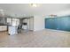 Open-concept living room featuring wood-look tile floors, recessed lighting, and seamless flow into the kitchen at 7135 W Flower St, Phoenix, AZ 85033