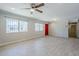 Inviting living room boasting wood-look tile flooring, neutral walls, and ample natural light from large windows at 7135 W Flower St, Phoenix, AZ 85033