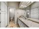Bright bathroom with a large mirror, lots of cabinets, and marble countertops at 7304 E Bent Tree Dr, Scottsdale, AZ 85266