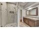 Modern bathroom featuring a glass shower with tile surround, a stone countertop vanity, and tile floors at 7304 E Bent Tree Dr, Scottsdale, AZ 85266