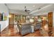 Open concept living area with hardwood floors, ceiling fan, and outdoor views through sliding glass doors at 7304 E Bent Tree Dr, Scottsdale, AZ 85266