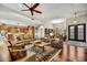 Spacious living room featuring hardwood floors, a ceiling fan, and a view of the kitchen at 7304 E Bent Tree Dr, Scottsdale, AZ 85266