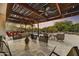 Covered patio featuring ceiling fans and lights for enjoying evenings overlooking the pool at 7304 E Bent Tree Dr, Scottsdale, AZ 85266