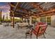 Large covered patio featuring seating, a ceiling fan, and views of the pool and desert landscape at 7304 E Bent Tree Dr, Scottsdale, AZ 85266